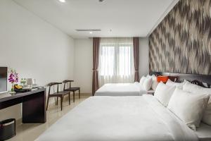 Postelja oz. postelje v sobi nastanitve Dylan Hotel Danang