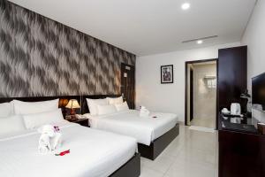 Postelja oz. postelje v sobi nastanitve Dylan Hotel Danang