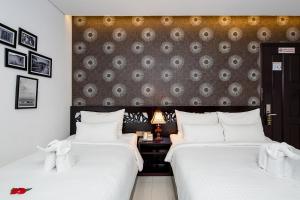 Postelja oz. postelje v sobi nastanitve Dylan Hotel Danang