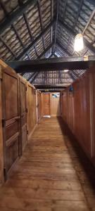 a long hallway with wooden stalls in a building at Ta Xua Ecolodge in Bắc Yên