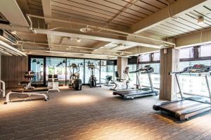 a gym with several treadmills and elliptical machines at The Gaia Hotel - Taipei in Taipei