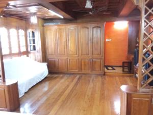 a bedroom with a bed and wooden cabinets at Court View Homestay in Cochin +1 photo