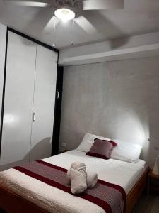 a bedroom with a bed with a towel on it at Garden Suite 1 Estación 48 in Mérida