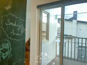 a window with a chalkboard on the side of a building at 〈二人部屋〉駐車場無料&地下鉄駅から950m、札幌新築戸建、施設が豊富、最大三名可能 in Sapporo
