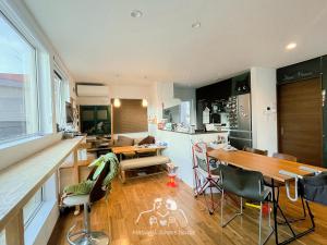 a kitchen and living room with a table and chairs at 〈二人部屋〉駐車場無料&地下鉄駅から950m、札幌新築戸建、施設が豊富、最大三名可能 in Sapporo