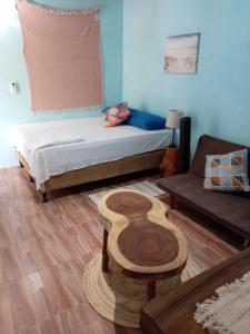 a room with a bed and a table and a couch at El Puente in El Paredón Buena Vista