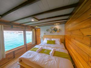 a bedroom with a bed in a boat at Phinisi Open Trip Komodo 3 days 2 Night in Limbung