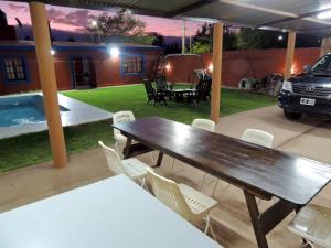 a patio with a table and chairs and a car at Alquiler de casa El Oeste in Villa Unión