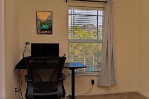 a desk with a laptop in a room with a window at Yosemite's Scenic Hideaway in Midpines
