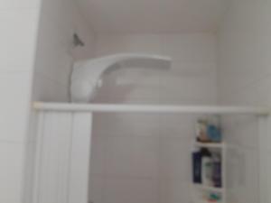 a sink in a kitchen with a white cabinet at Eduardo Gimenes Palazzi in São Vicente +11 photos