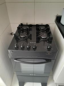 a black stove top oven in a kitchen at Eduardo Gimenes Palazzi in São Vicente
