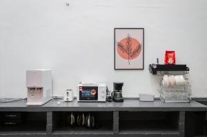 a table with a counter top with a microwave at Aayu Melayu in George Town