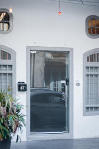 a door to a building with a car in it at Aayu Melayu - George Town Penang in George Town