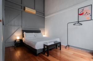 a bedroom with a bed and a chalkboard on the wall at Aayu Melayu - George Town Penang in George Town