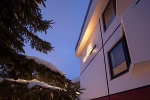 a building with a light on the side of it at M Lodge in Niseko