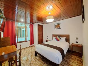 Postel nebo postele na pokoji v ubytování Inti Pacha Palace Machupicchu