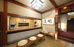 a waiting room with two benches and a counter at Wakamatsu Honten in Narita