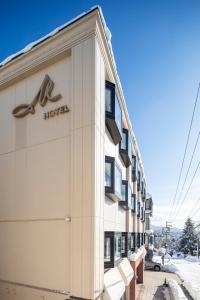 a hotel sign on the side of a building at M Hotel Niseko in Niseko