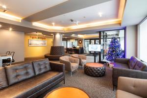 a lobby with couches and a christmas tree at M Hotel Niseko in Niseko