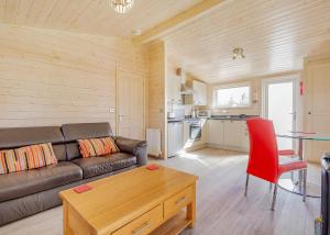 a living room with a couch and a table at Messingham Lakes in Messingham