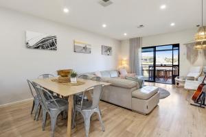 a living room with a table and a couch at 3 61 St Andrews Boulevard in Normanville