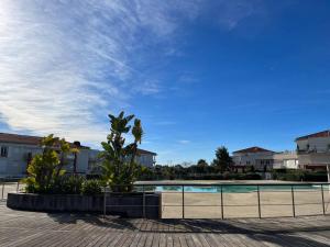 a swimming pool in a resort with a blue sky at Modern Condo w Terrace 250m from Beach & Pool in Antibes