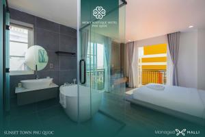 a bathroom with a tub and a sink and a shower at Merci Hotels - Sunset Town Phu Quoc in Phú Quốc