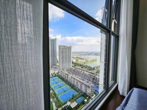 einen Blick auf die Stadt aus dem Fenster eines Hotels in der Unterkunft Căn góc Masteri 2N+ view hồ đẹp in Hanoi