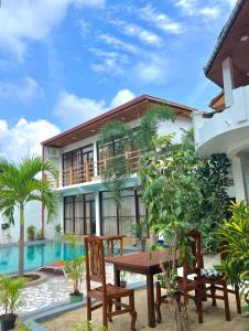 a house with a table and chairs in front of it at Artist Village in Arugam Bay