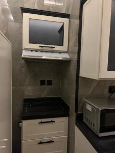 a microwave sitting on a shelf in a kitchen at شقه بطراز نجدي فاخر 2 in Riyadh