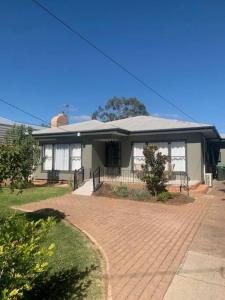 a house with a brick driveway in front of it at Family home central to everything in Mildura