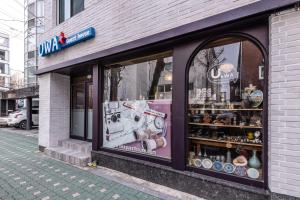un negozio di fronte a un negozio in una strada di città di UWA Guesthouse a Seul