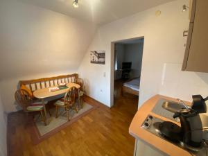 a small kitchen with a table and a room with a bed at No.5 - Apartmenthaus in Stein in Stein