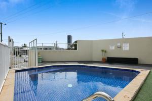 a swimming pool on the roof of a house at Sleek Apartment with Pool and Rooftop Terrace in Gold Coast
