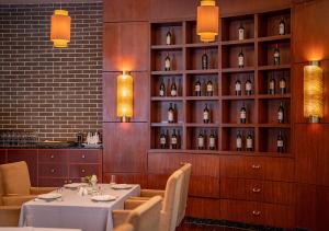 a dining room with a table and bottles of wine at Yiwu Ocean Hotel - Original Best Western Premier Ocean Hotel in Yiwu