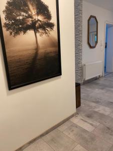 a picture of a tree hanging on a wall at 76 qm wohnen - Wohnung 1 - CSL UG in Bensdorf