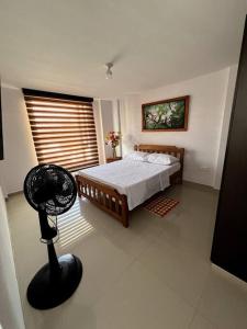 a bedroom with a bed and a fan in it at Acogedor apartamento en San Gil. in San Gil
