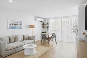a living room with a couch and a table at Spacious 1-Bed in the Heart of Teneriffe in Brisbane