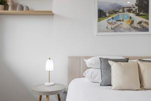 a bedroom with a bed and a table with a lamp at Spacious 1-Bed in the Heart of Teneriffe in Brisbane