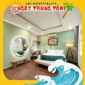 a hotel room with a bed and a wave themed room at Joi Hospitality - Central in Vung Tau