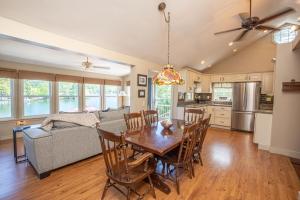 a kitchen and living room with a table and chairs at Sunset Cottage #3 in Hamilton