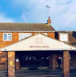 a building with an awning on the front of it at OYO The Rivenhall Hotel in Witham