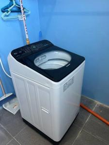 a washing machine sitting on the floor in a room at ALMAR APARTELLE in Oroquieta