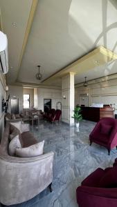 a large living room with a couch and chairs at Radiha Hotel Suites in Al Ḩawīyah