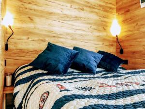 a bedroom with a bed with two lights on it at Glamp-stan-slapy cz in Neveklov