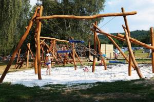 a group of people playing on a playground in the sand at Glamp-stan-slapy cz in Neveklov