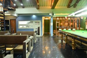 a billiard room with a pool table and chairs at Zingo's Home Stay in Darjeeling