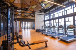 a gym with a row of treadmills and machines at Societe Hartamas in Kuala Lumpur