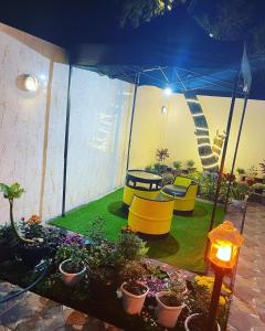 a backyard with a playground with a slide and plants at Villa Omar in Cikujang +3 photos