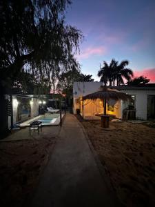 a house with a swimming pool and an umbrella at Kika in Limpio